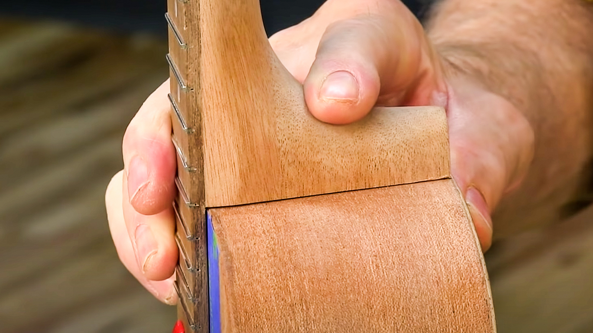 Hände passen Ukulele-Hals an Körper